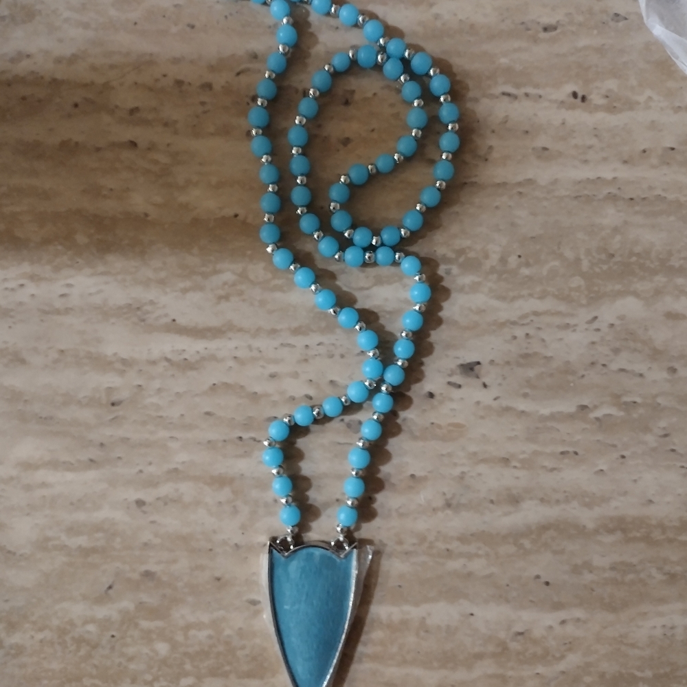 The arrowhead necklace set. It comes with a silver bar necklace that says pink z